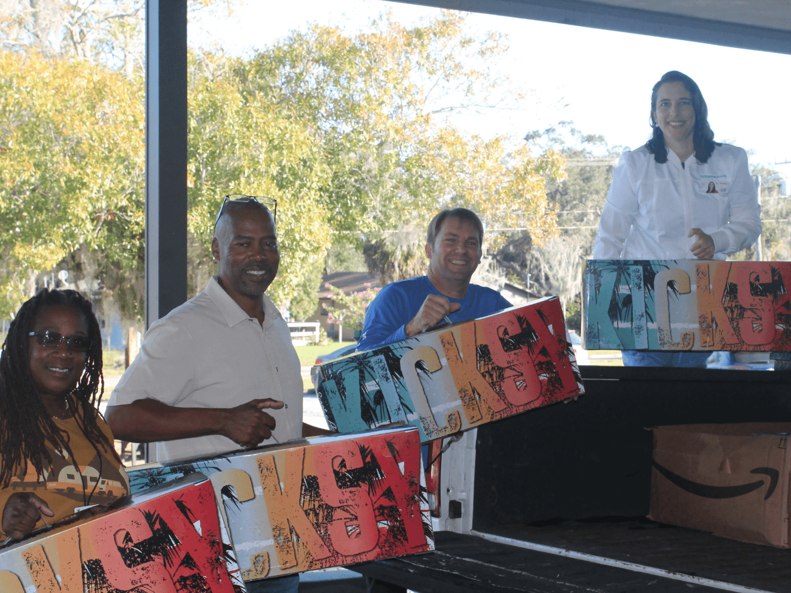 Starr Wingfield, Willie Hawkins, Jason Young and Dr. Summer Young post holding scooters being donated to Eustis Head Start program.